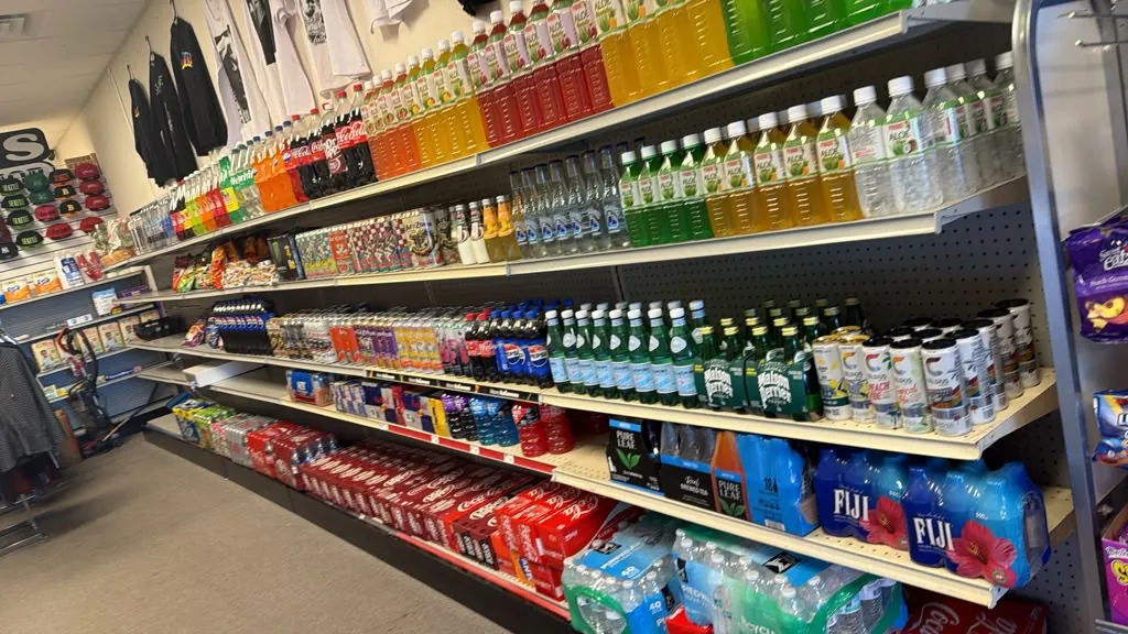 An aisle of bottled water, sports drinks, and juices