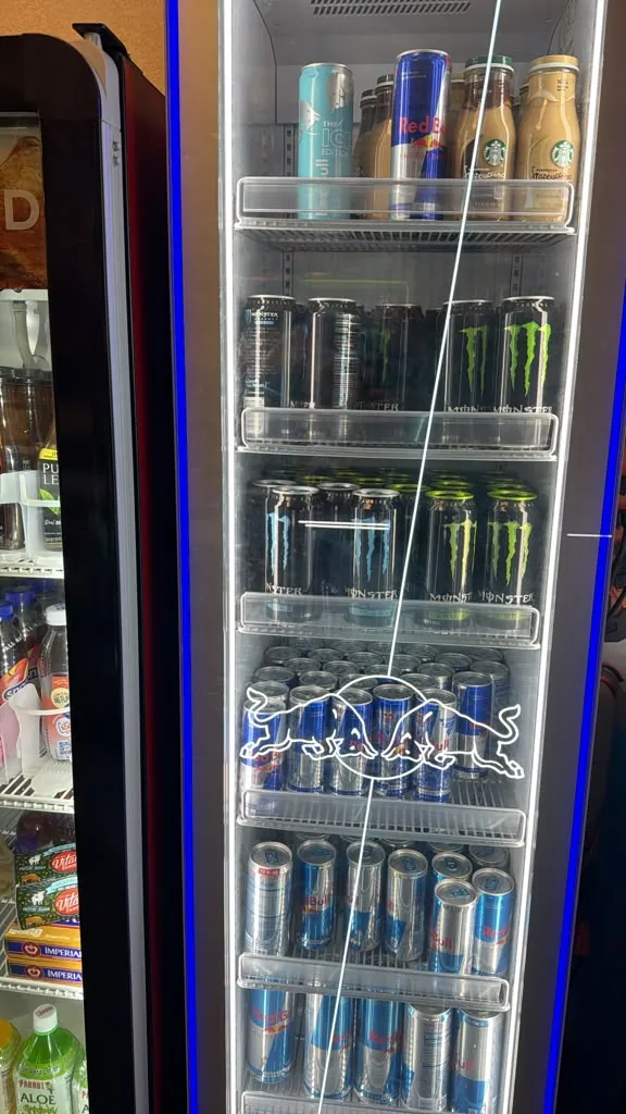 A cooler stocked with energy drinks and coffee drinks