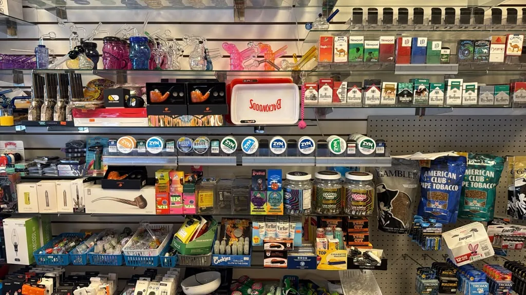Pipe tobacco, nicotine pouches, and glass on the wall